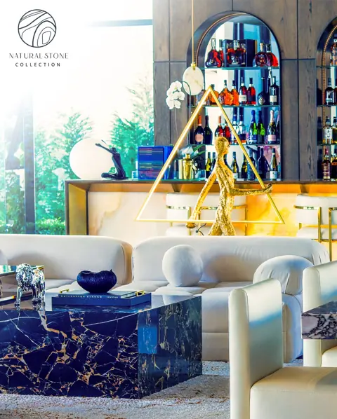 Blue stone with golden veins is used for the coffee table and living area, alongside comfortable seating and a restrained neutral palette.