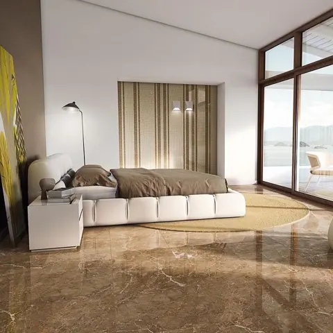 Rich brown veined stone is used for the floor throughout the room, alongside comfortable seating and a restrained neutral palette.